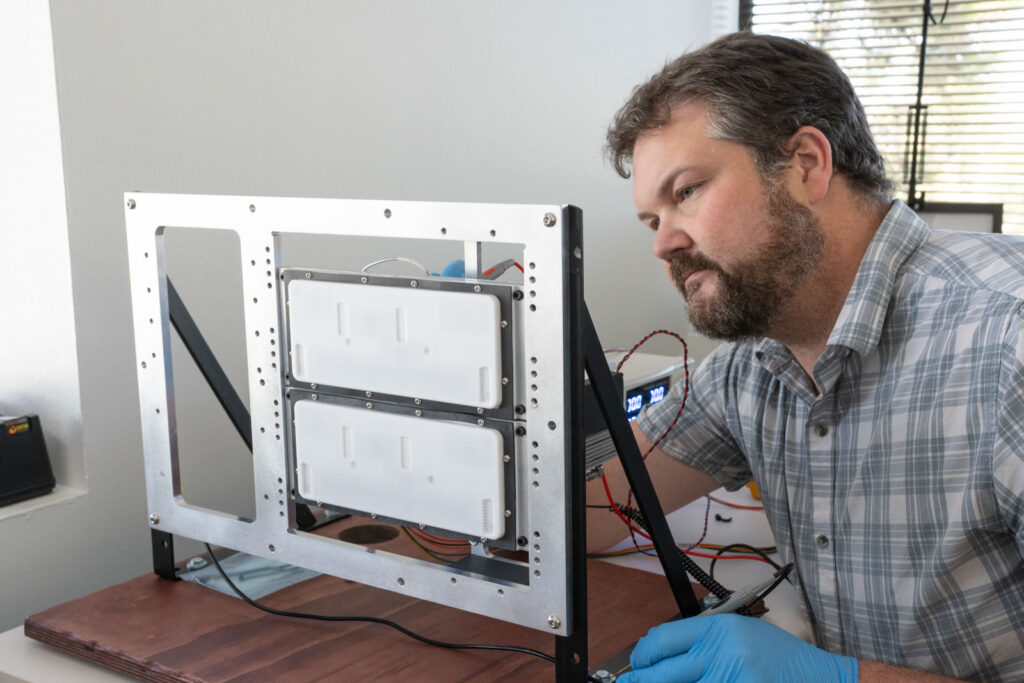 Engineer inspecting an antenna panel test fixture