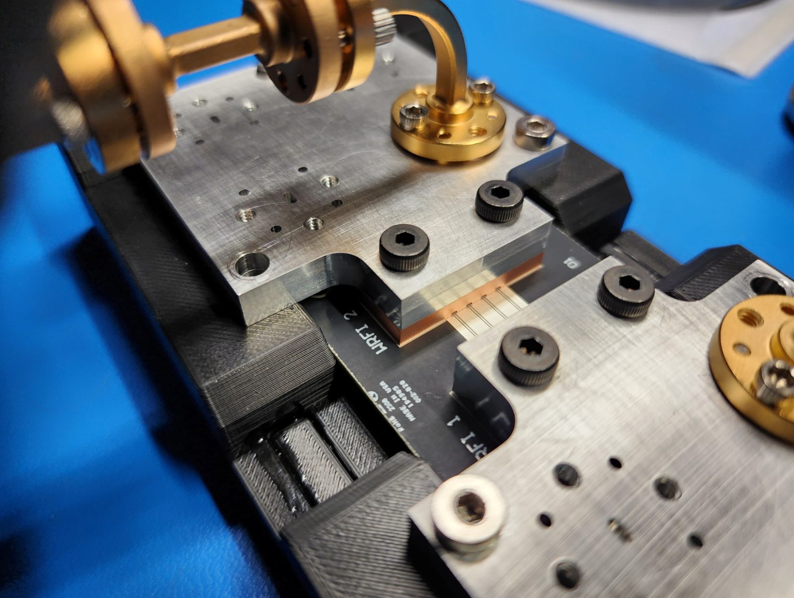 Millimeter-wave interposer test fixture with waveguide flanges